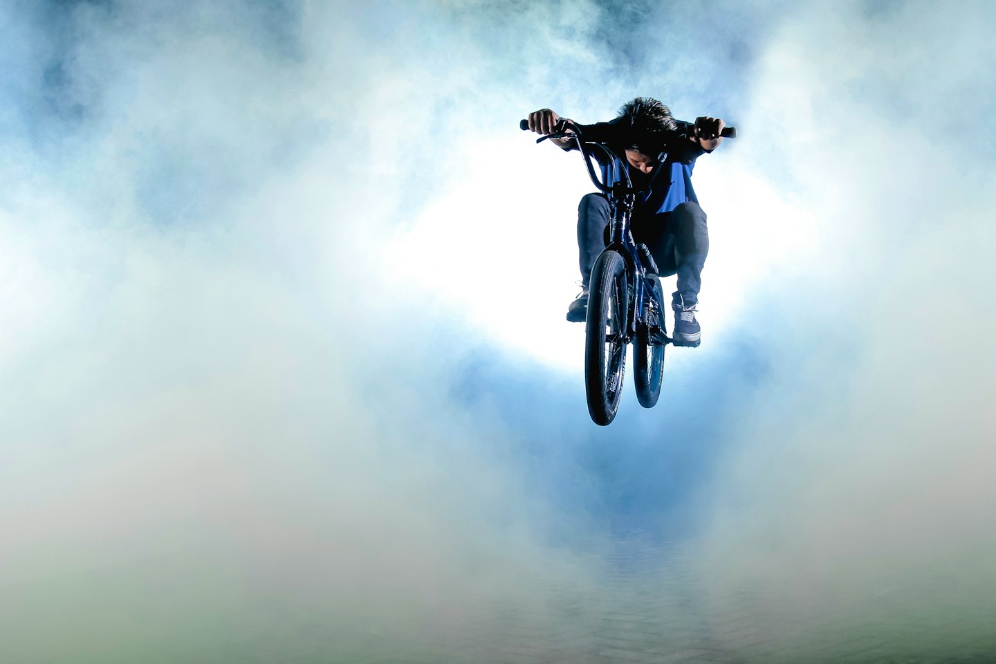 Person performing a mid-air BMX bike stunt.